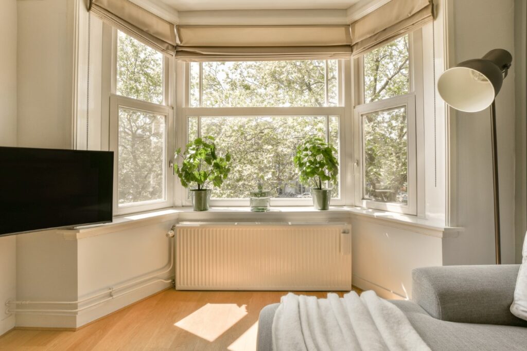 a living room with a radiator and a large window